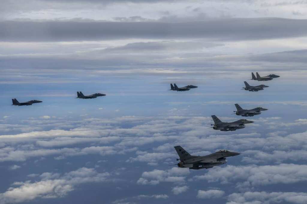 North Korea's fighter planes fly near border, tests another missile