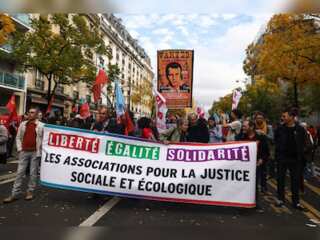 Protesters in Paris march against rising cost of living and climate crisis