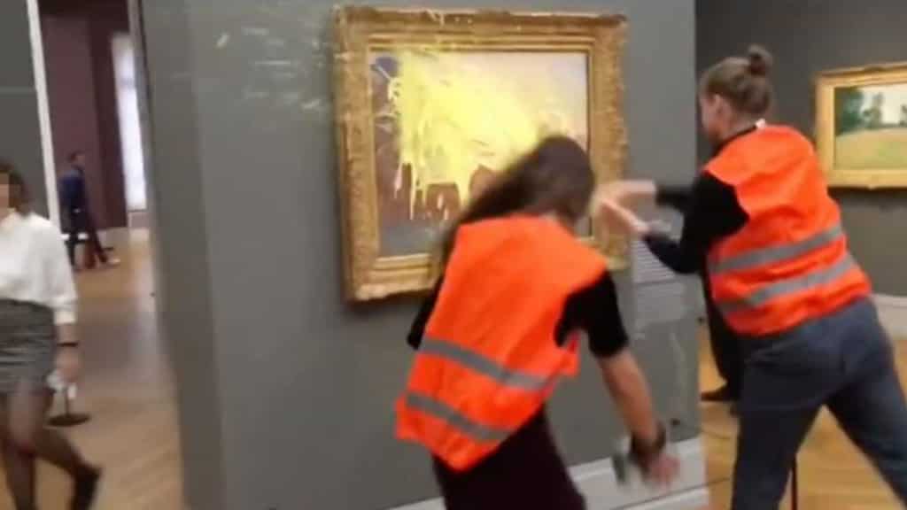 A pair of 'climate activists' throw mashed potatoes at Monet's Les Meules painting
