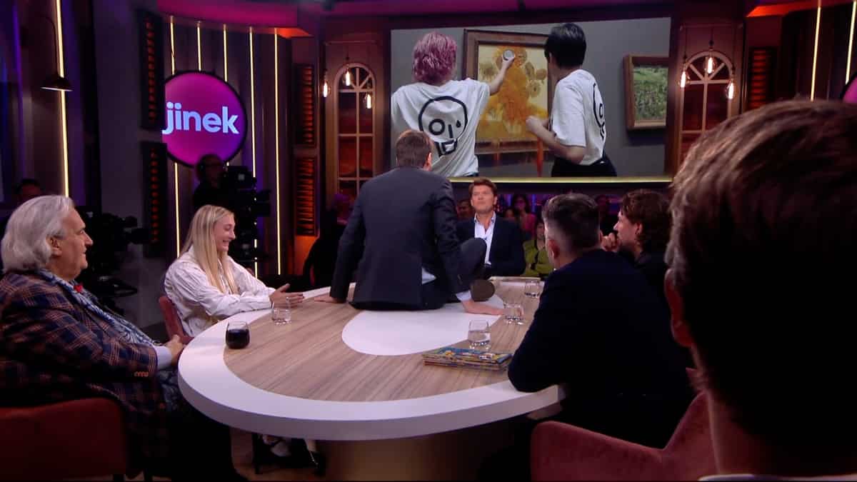 Watch: Climate activist glues himself to table on a Dutch talk show Watch: Climate activist glues himself to table on a Dutch talk show