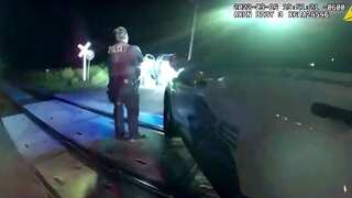 US: Two police officers charged with leaving handcuffed woman in car that was hit by train