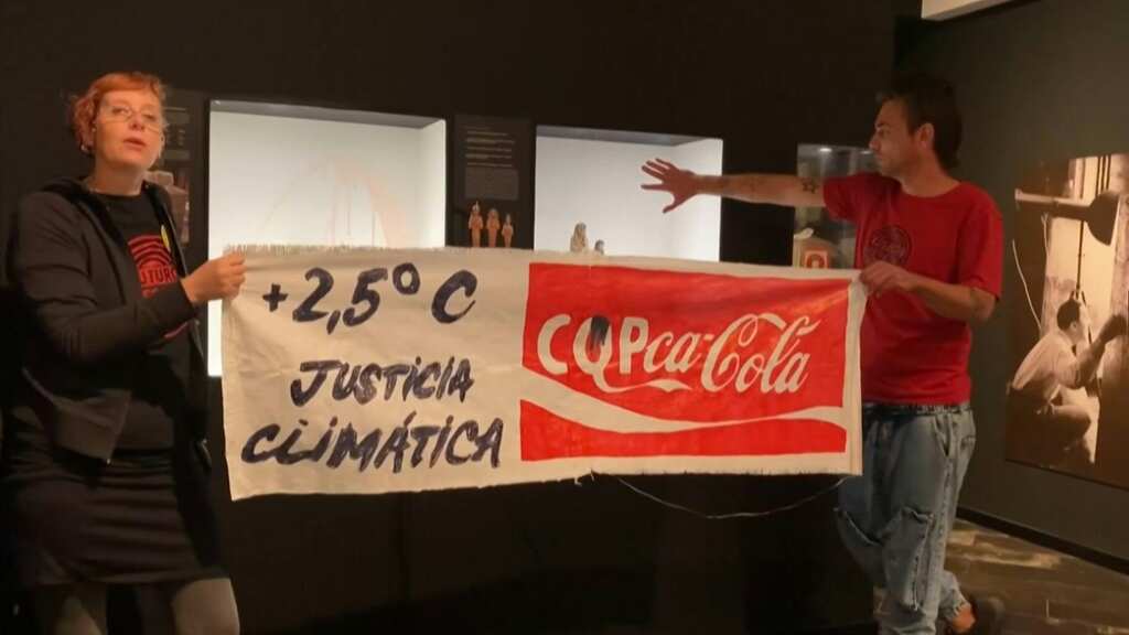 Spanish climate activists splash viscous liquid over a glass case of fake mummy at Barcelona's Egyptian Museum