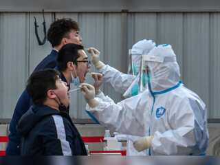 China's economic activity falls as Covid-19 cases surge to record