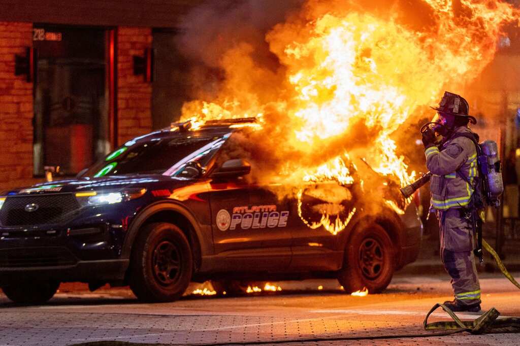 Protest turns violent in Atlanta, activists question official version in the latest shooting