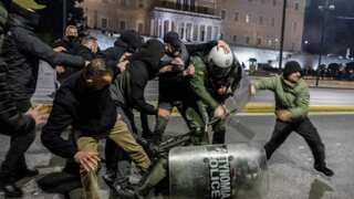 'Murderers!': Thousands of protesters clash with police across Greece over deadly train collision