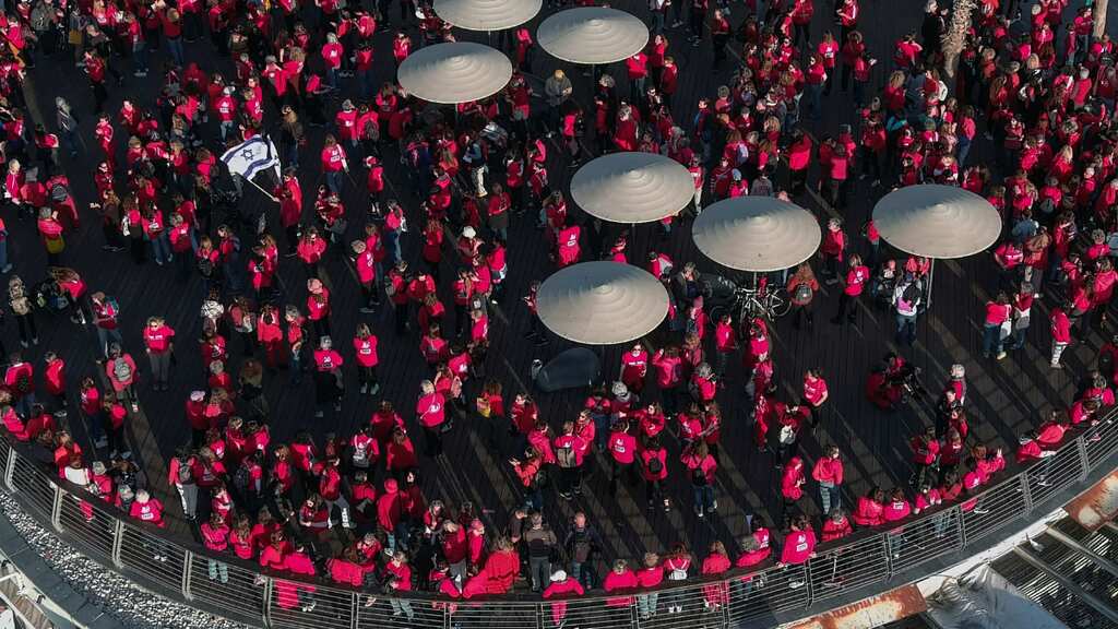 Women dressed in red form human chains to protest judicial overhaul in Israel