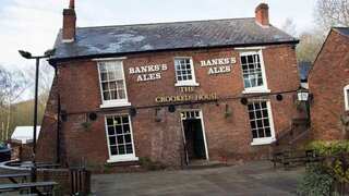 Britain's wonkiest pub 'The Crooked House', where coins roll uphill, up for sale