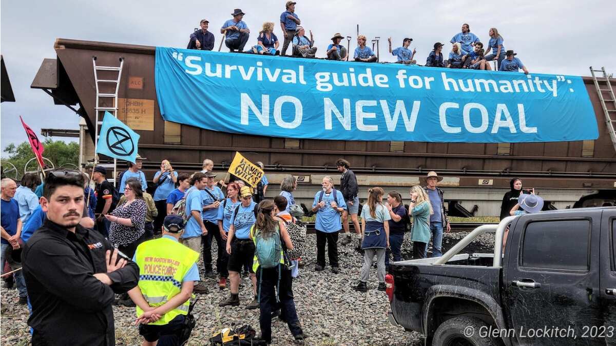 Climate activists held for shovelling out coal from a train in Australia