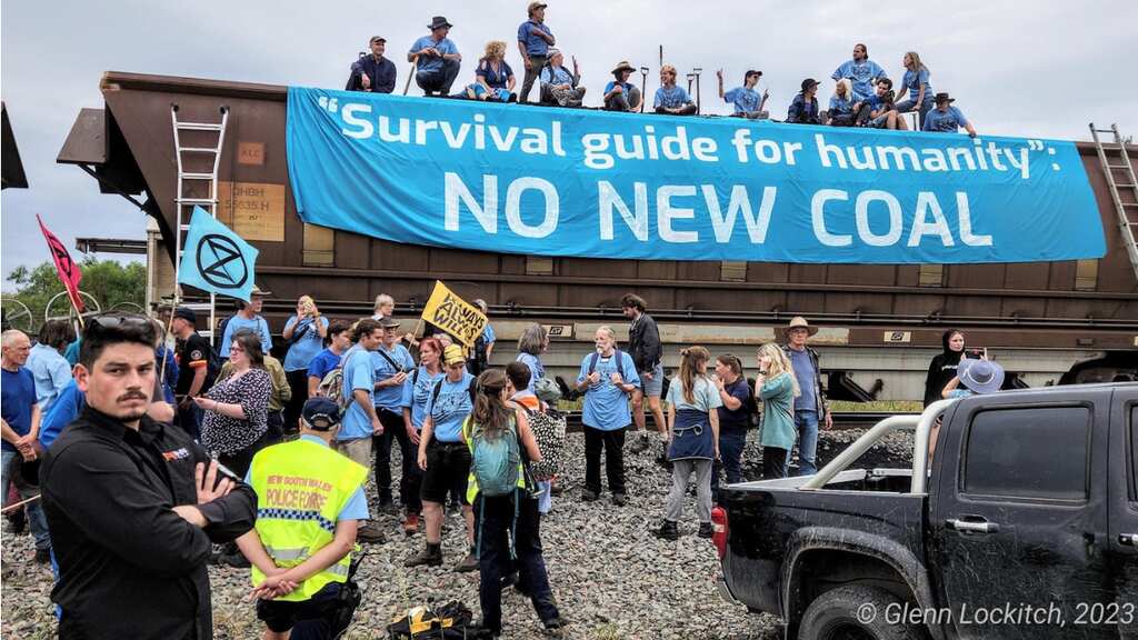 Climate activists held for shovelling out coal from a train in Australia