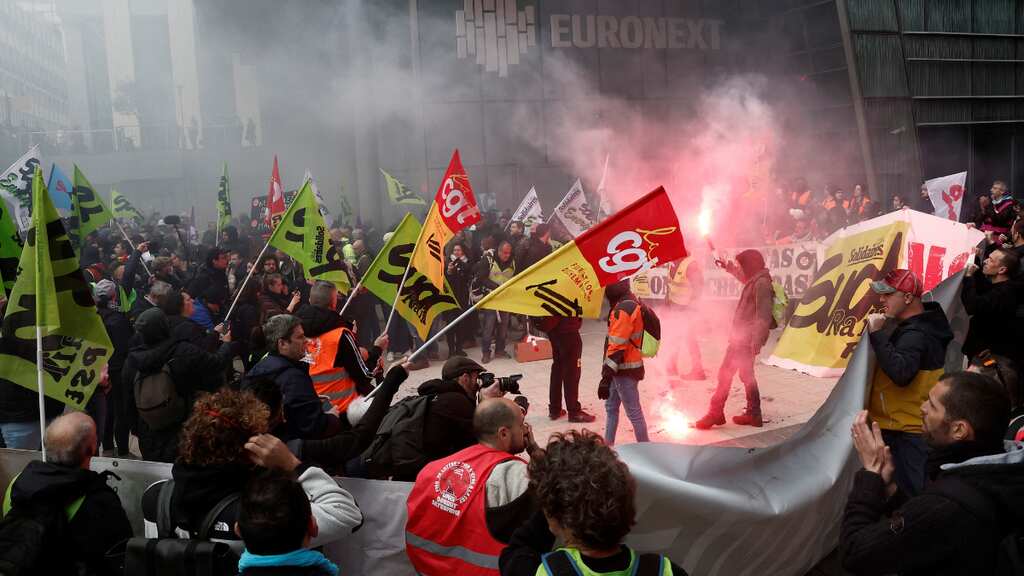 Angry protesters storm Paris Euronext building; tear gas fired as Macron continues trip