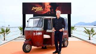 Harrison Ford poses in front of tuk-tuk at Cannes' Carlton beach to promote new film
