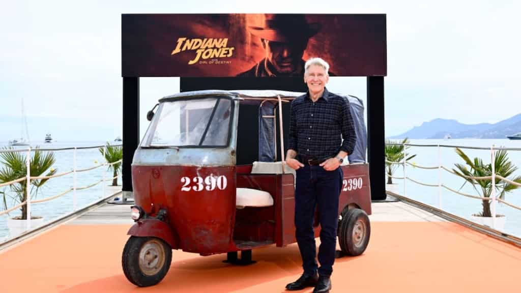 Harrison Ford poses in front of tuk-tuk at Cannes' Carlton beach to promote new film