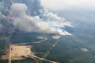 Canada: Wildfire smoke choking citizens but proving helpful to cool blazes