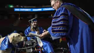 WATCH | Service dog receives honorary diploma along with owner at graduation ceremony