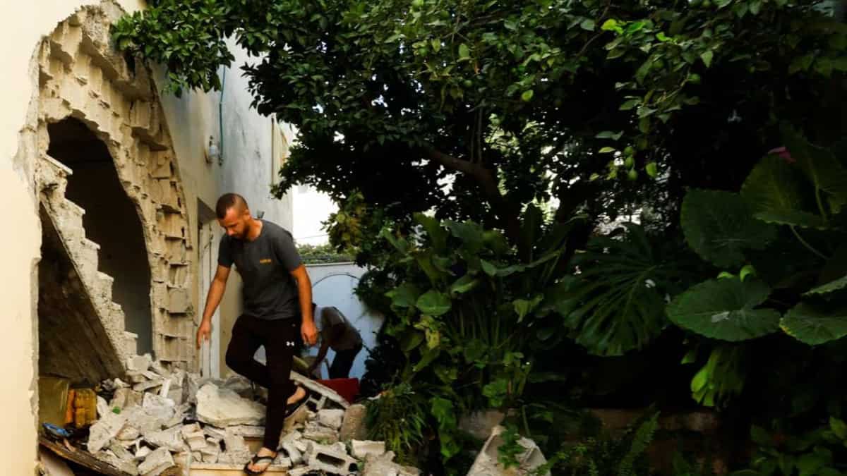 Following Israeli army's pullout from the Jenin camp, Palestinians walk over rubble
