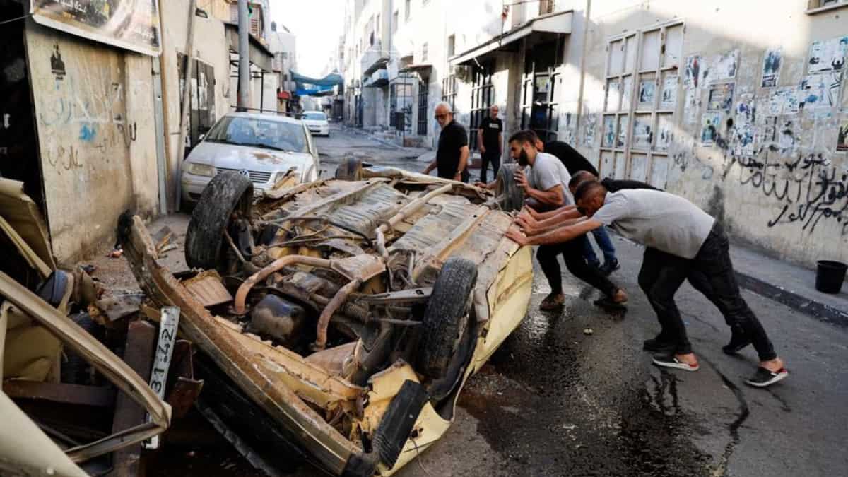Palestinians lifting up cars