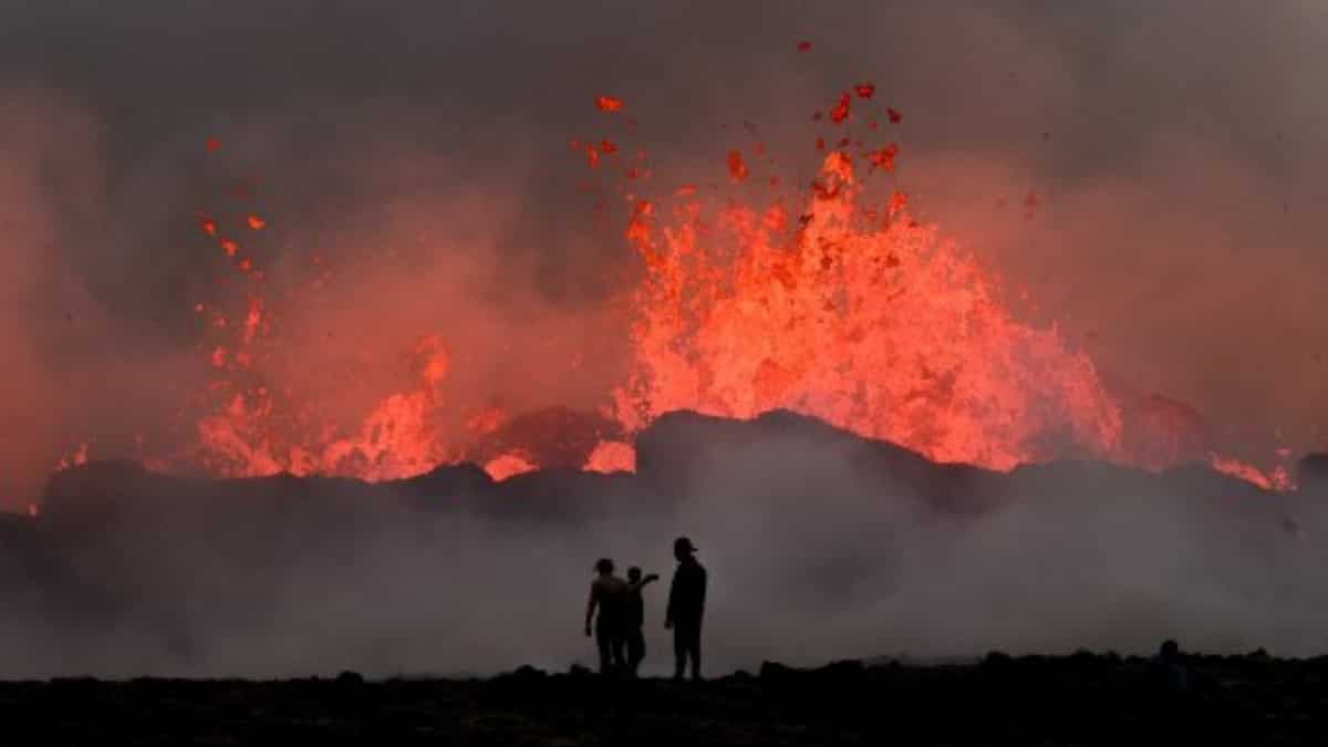 People rever in at the site of the erupting volcano