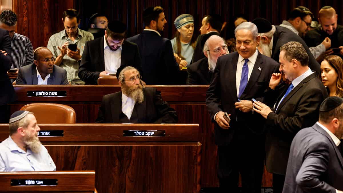 Israeli PM attends parliament vote, defends decision