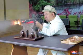 North Korea's Kim Jong Un tours key weapons factories, fires assault rifles