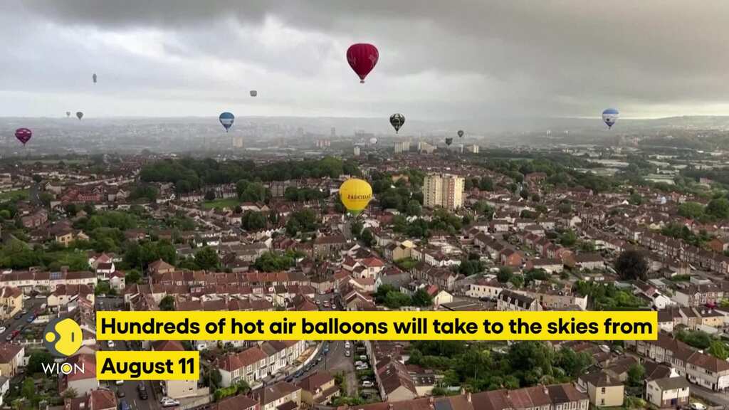 Hot air balloons fill the sky over the city of Britain