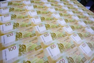 Russian ruble drops to 100 against dollar for first time since March 2022