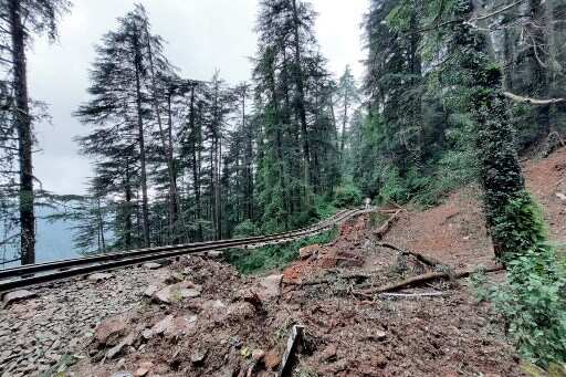 Villagers gather at the site of a landslide