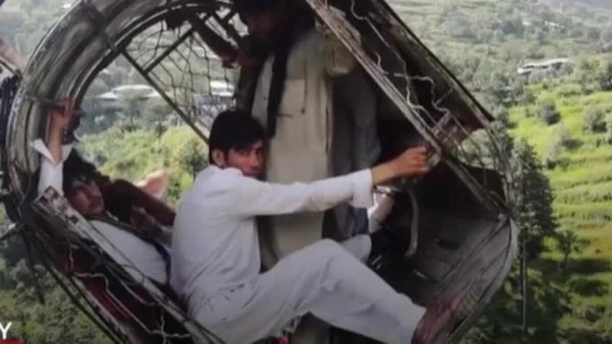 Chilling drone footage shows people dangling in stranded cable car right above ravine in Pakistan