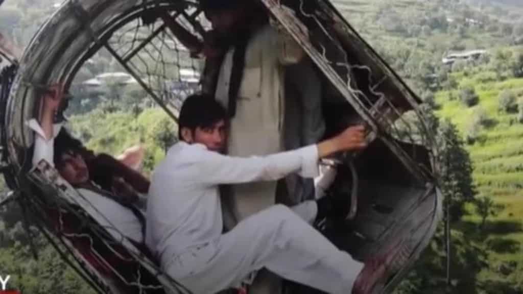 Chilling drone footage shows people dangling in stranded cable car right above ravine in Pakistan