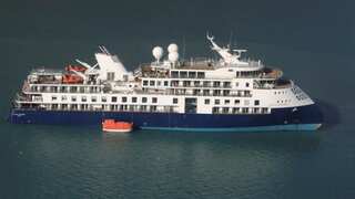 Luxury cruise ship remains grounded in Greenland with help days away