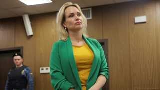 Russian journalist who flashed anti-war placard on air sentenced to over 8 years in jail