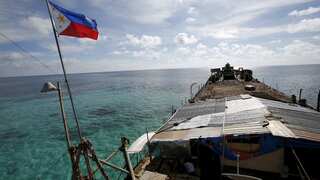 China again warns Philippine vessels supplying troops in disputed waters