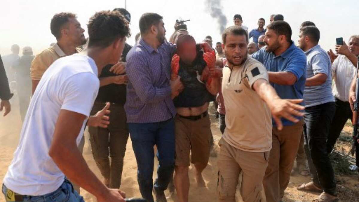 Palestinians with captured Israeli man