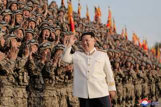 North Korea rushes troops, heavy weapons near border with South, warns of more satellite launches