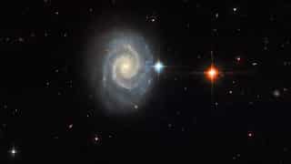 Celestial masterpiece: Forbidden light of distant spiral galaxy captured by Hubble