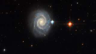 Celestial masterpiece: Forbidden light of distant spiral galaxy captured by Hubble