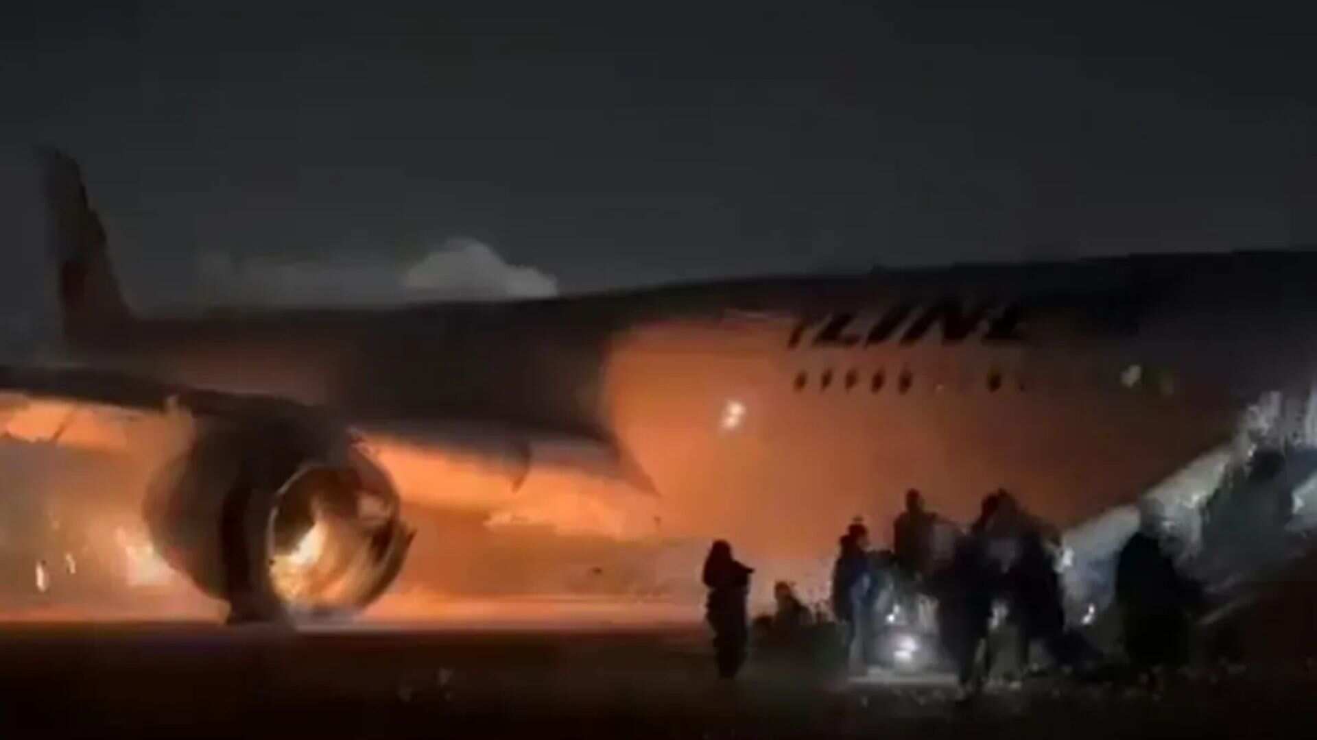 Japan: Passengers slide down inflatable ramp from burning plane. Watch Japan: Passengers slide down inflatable ramp from burning plane. Watch
