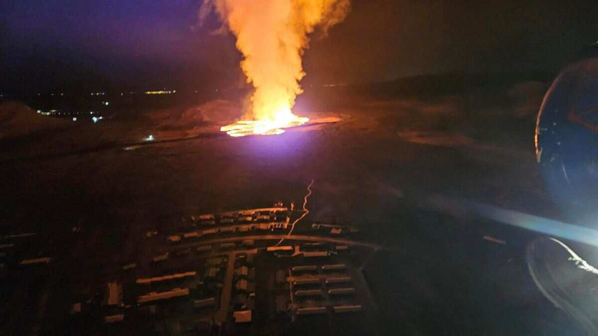 Flowing lava reaches fishing town