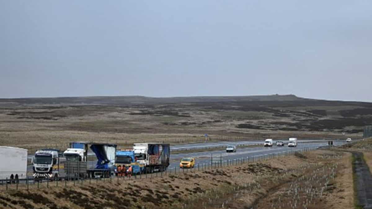Workers recover lorries blown over