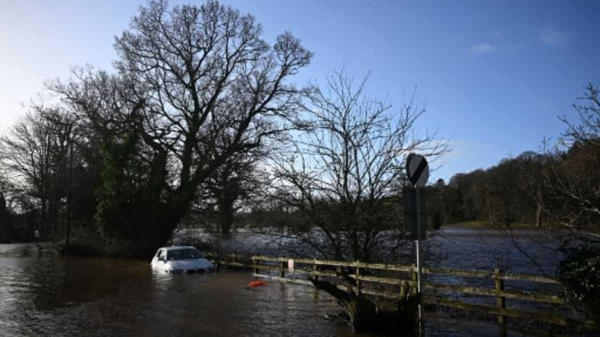 Floodwater water surrounds car