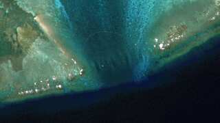 Satellite images reveal floating barrier at mouth of disputed atoll in South China Sea