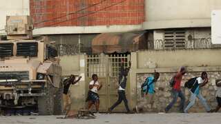 Gun battles rage in Haiti as gang leader pushes for PM's ouster