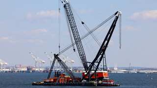 Baltimore bridge collapse: Flammables, corrosives found on ship as largest crane helps clear channel