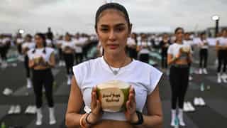 'Feel like a beautiful bird': Mass yoga session takes place on Bangkok airport tarmac