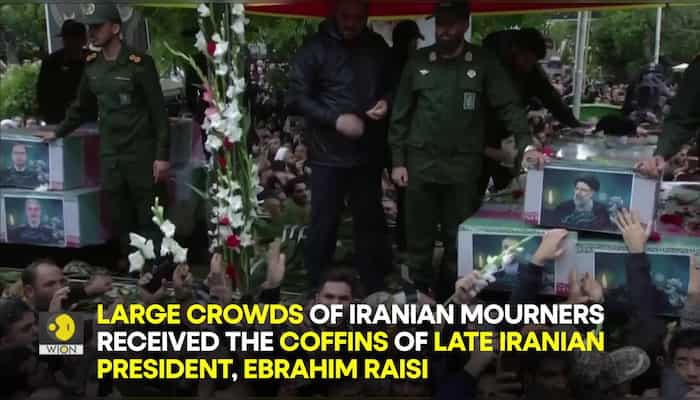 Ebrahim Raisi's funeral: Iranian mourners receive Raisi's coffin during funeral procession