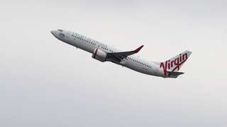 Australian man disrupts flight by running naked in aisle, knocking down crew member