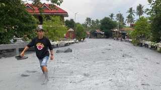 Heavy rain washes cold lava and debris through Philippines village - see pics
