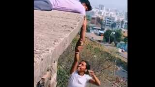 Idiotic stunt to check grip strength: Woman in India's Pune hangs from building holding man's hand. Watch
