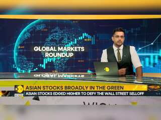 Asian stocks edged higher to defy the Wall Street selloff