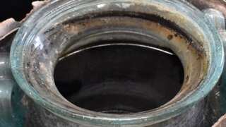 Sealed and filled jar of wine recovered with burials of dead Roman in tomb