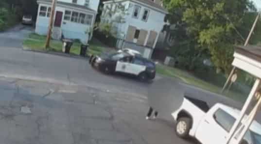 Watch: Man carries dead body on his back the exact moment a police cruiser drives by